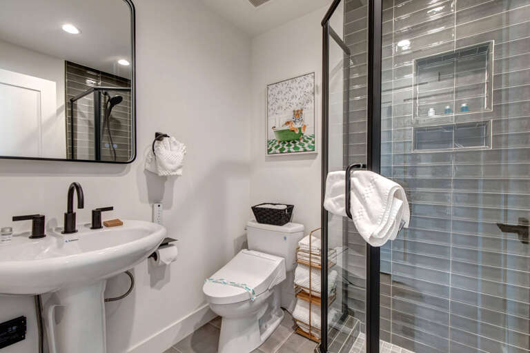 Upper Main 301: Refresh in your modern bathroom with sleek subway tile shower, contemporary fixtures, and thoughtful touches like fluffy towels waiting for you.