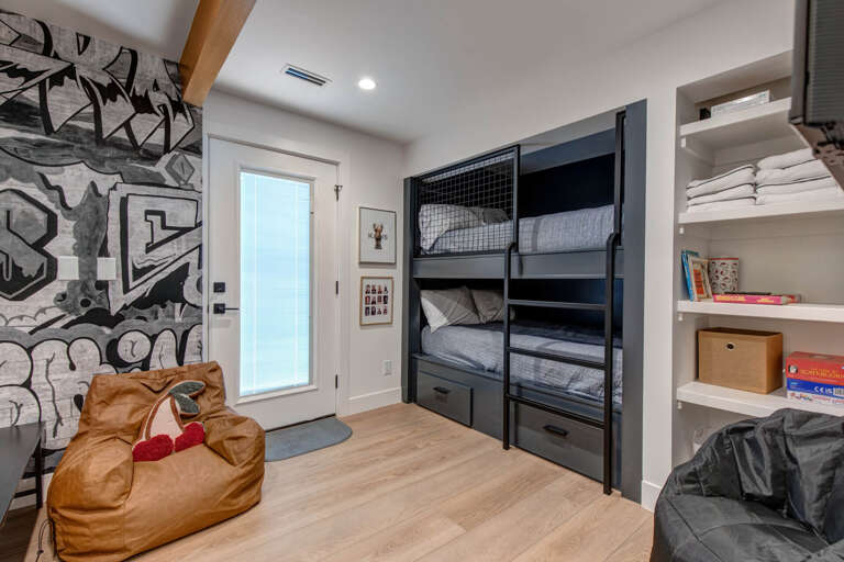 Upper Main 301: Your kids will love this fun bedroom with built-in bunk beds and vibrant wall art that sparks imagination.