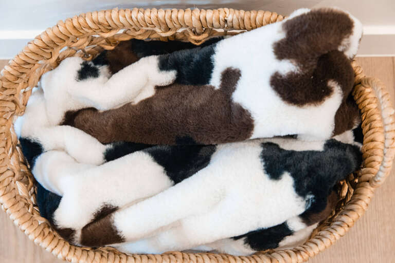 Cozy up with these soft, plush slippers waiting in your wicker basketâperfect for padding around your home away from home.