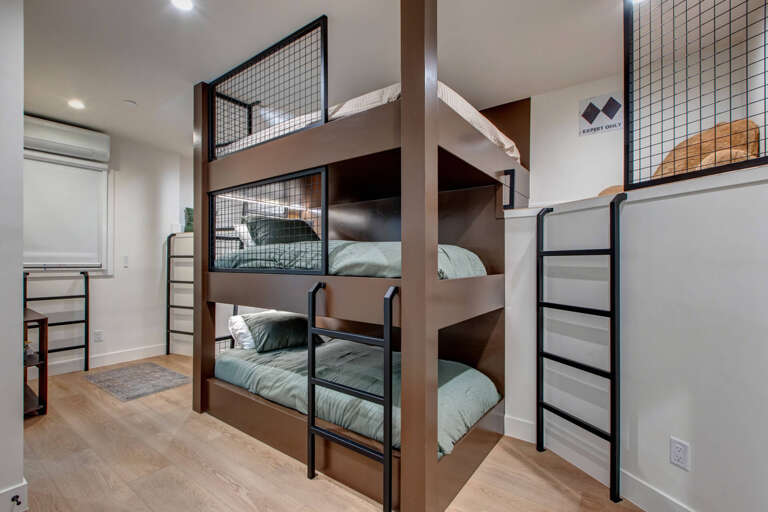 Sleep soundly in your own cozy bunk with soft bedding, personal reading light, and privacy curtains in this thoughtfully designed shared room.