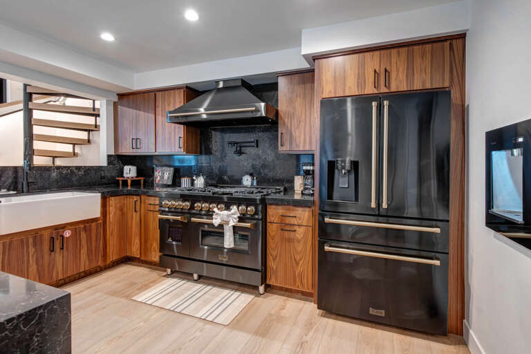 Upper Main 301: Your gourmet kitchen features rich walnut cabinetry, professional-grade appliances, and elegant granite counters where culinary dreams come alive.
