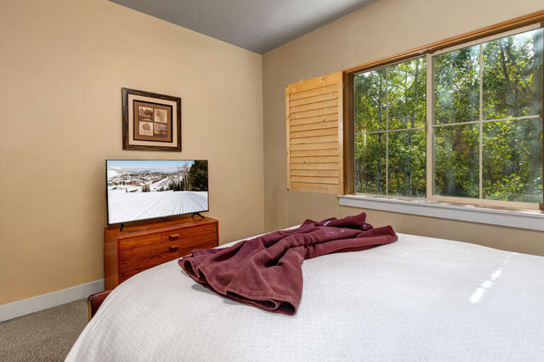 Wake up in your serene bedroom with garden views streaming through your window. Enjoy modern comforts like a flat-screen TV while feeling surrounded by nature.