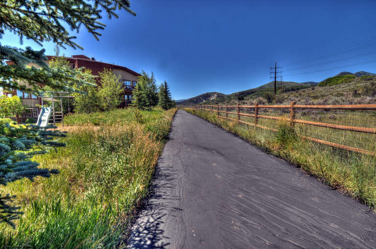 Property nestled along a scenic path with mountain views and nearby hiking trails, perfect for outdoor adventures.