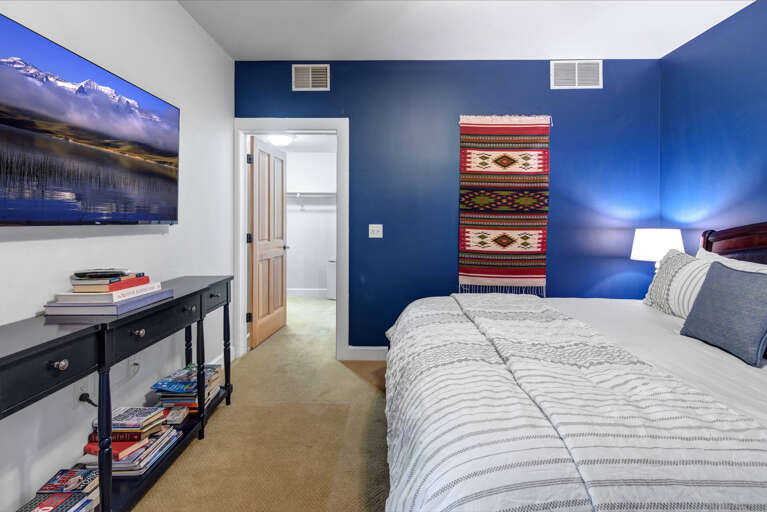 Crestview Commons A207: Primary king bedroom with attached spa-like ensuite bathroom with dual sinks.