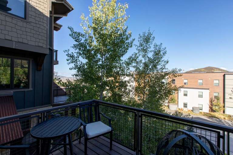 This balcony offers a serene view of the surrounding neighborhood and nearby mountains, providing a pleasant spot to enjoy the property's location and the natural beauty of the area.