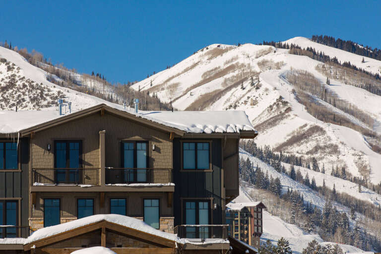 Mountain resort property nestled at the base of pristine ski slopes, offering breathtaking alpine views and direct access to winter activities.