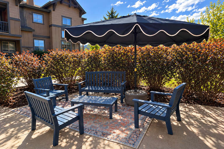 Private patio and entrance to a multi-level townhome-style vacation rental, featuring fall landscaping and mountain contemporary architecture in a peaceful residential setting.