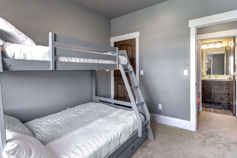 Relax into your peaceful retreat with cozy bunk beds and convenient access to your private ensuite bathroom, ready for a restful night's sleep.