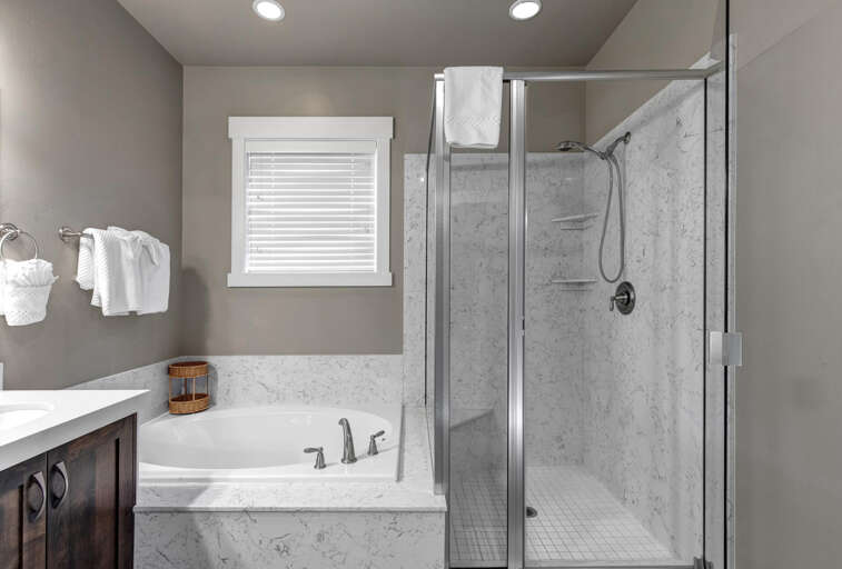Parks Edge 13631: Primary bathroom with soaking tub and walk-in shower