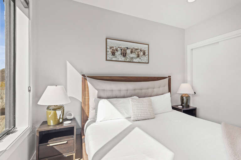 Sink into crisp linens and let natural light fill your restful retreat, where modern comfort meets rustic charm in every thoughtful detail.