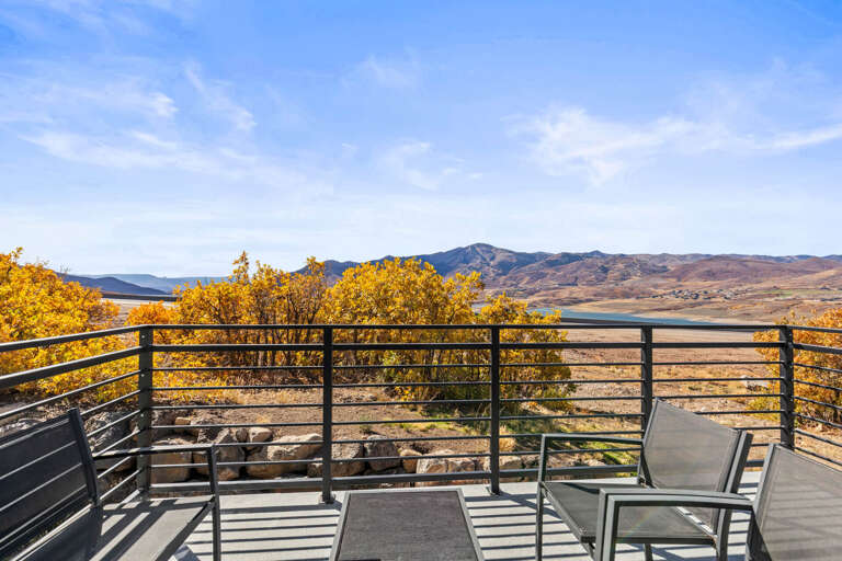 Sweeping mountain and lake views frame the property's scenic location, with golden autumn foliage and distant peaks defining the natural landscape surrounding the area.