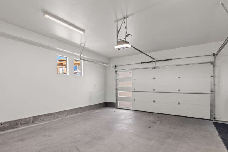 A spacious, well-lit garage offers convenient parking and extra storage space for all your vacation gear and equipment.