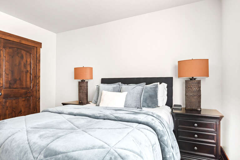 Sink into cloud-soft bedding and unwind in your elegant retreat, where warm lighting creates the perfect ambiance for restful nights.