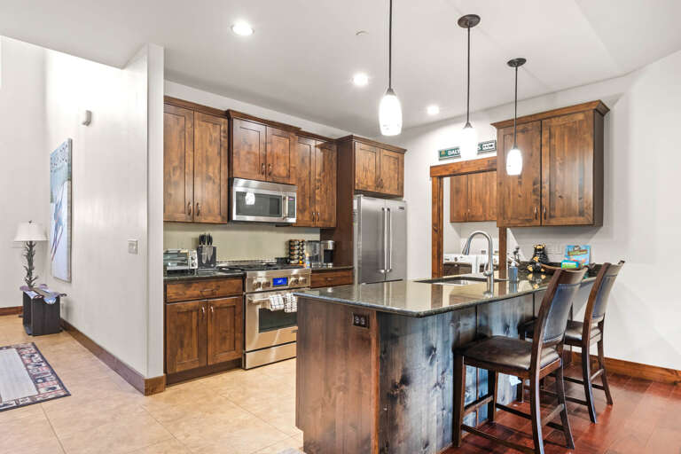 Your gourmet kitchen features rich wood cabinetry, granite countertops, and stainless steel appliances for memorable cooking experiences.