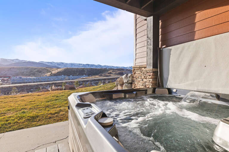 Soak in your private hot tub while gazing at stunning mountain views. Pure relaxation awaits on your covered patio.
