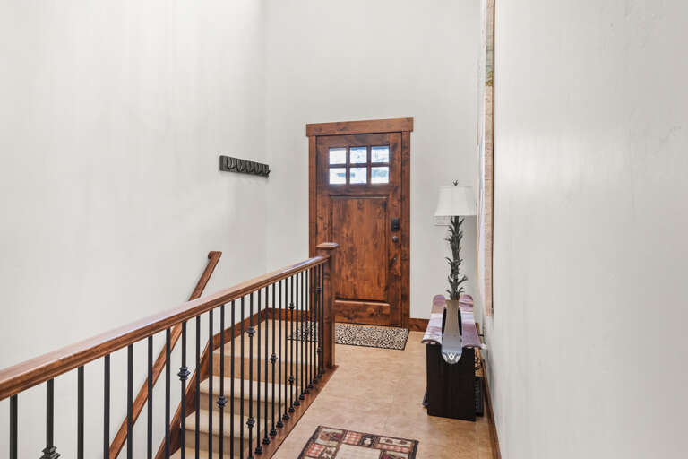 Step into your welcoming upstairs hallway, where warm wood tones and thoughtful touches create a cozy mountain retreat atmosphere.