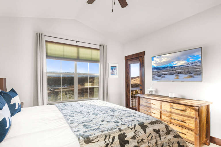 Wake up to stunning mountain views from your comfortable bed, with a ceiling fan overhead and spacious dresser for your belongings.