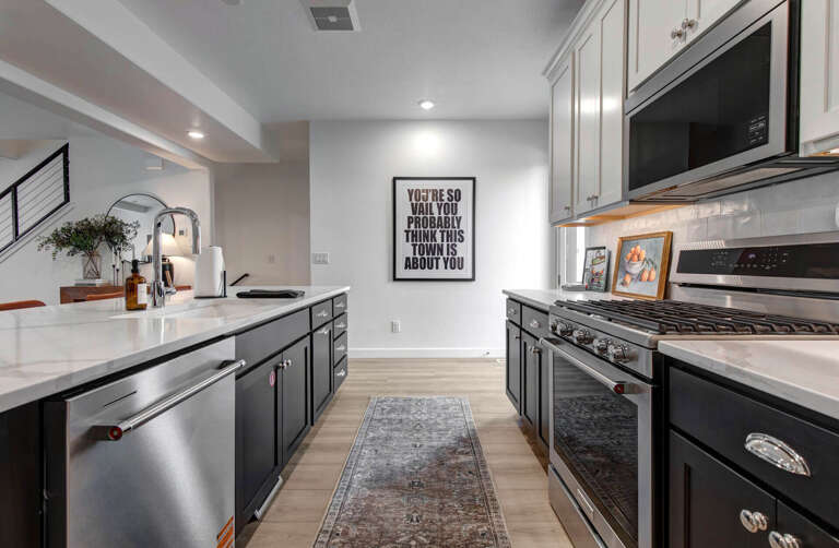 Cook your favorite meals in this stylish galley kitchen featuring stainless steel appliances and elegant countertops.
