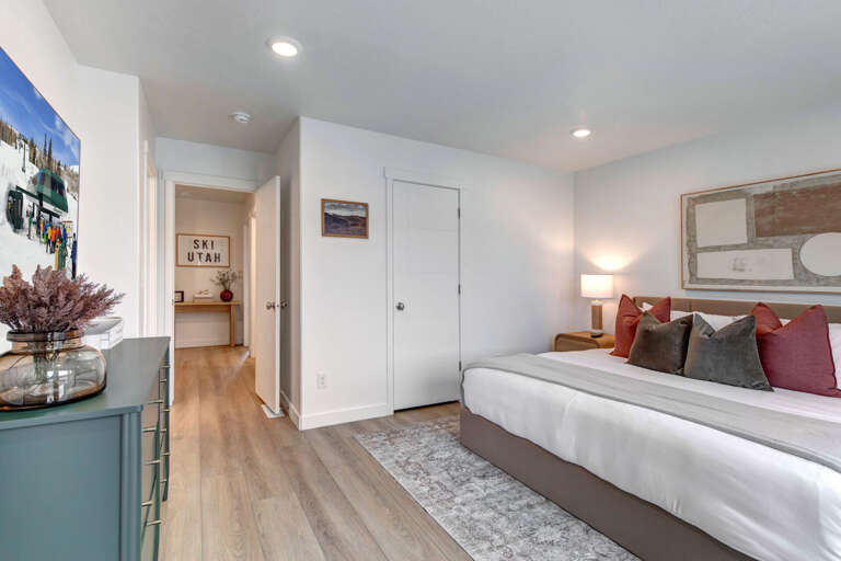 Sink into your king-size bed surrounded by colorful pillows and warm lighting for the perfect mountain getaway retreat.