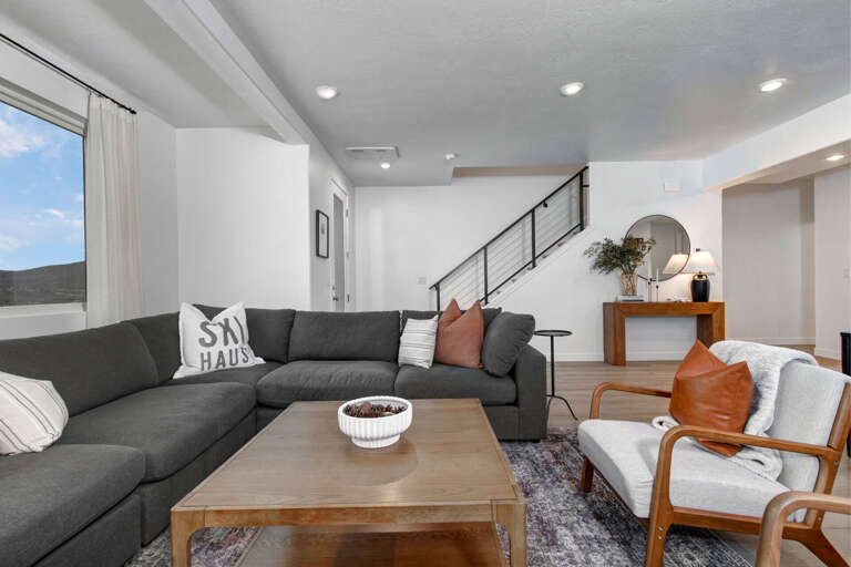 Sink into your spacious sectional and enjoy the open-concept design with modern touches throughout this bright, airy living space.