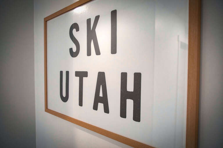 A stylish framed 'SKI UTAH' print adorns your wall, setting the perfect alpine mood for your mountain getaway adventure.