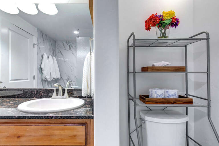 Fresh towels await you in this bright bathroom, thoughtfully organized for your comfort and convenience.