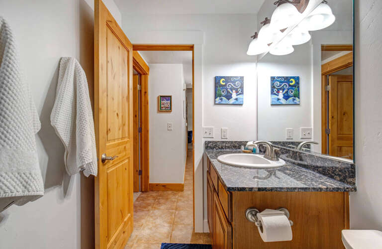 Freshen up in your beautifully appointed bathroom with granite countertops, warm wood cabinetry, and soft towels waiting for you.