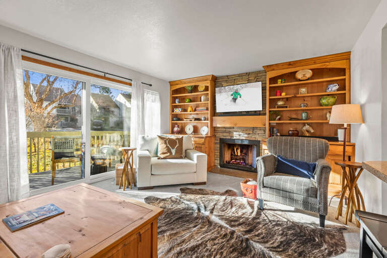 Cozy up by your crackling fireplace while enjoying mountain views through your sliding doors to your private deck.