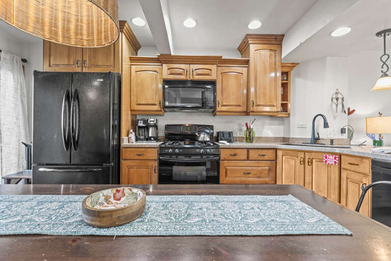 You'll love cooking in this fully equipped kitchen with granite counters, stainless appliances, and warm wood cabinetry.