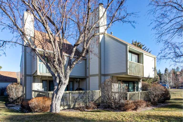Modern townhouse complex featuring two-story units with private balconies and peaceful residential setting.