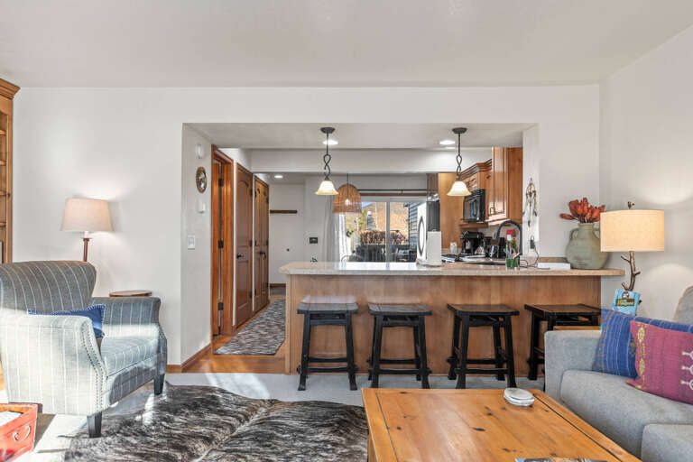 Your open-concept living space flows seamlessly from cozy seating to a fully equipped kitchen, perfect for gathering with loved ones.