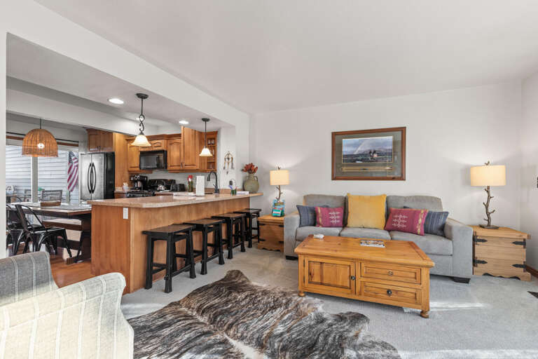 Relax in this open-concept living space where your family can gather around the cozy sofa while meals are prepared in the well-equipped kitchen.