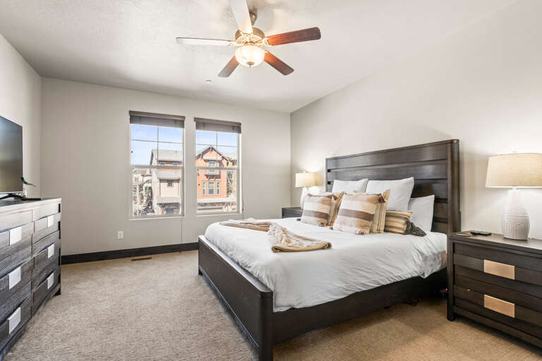 Drift off in your cozy bedroom with plush bedding and a gentle ceiling fan keeping you comfortable all night long.
