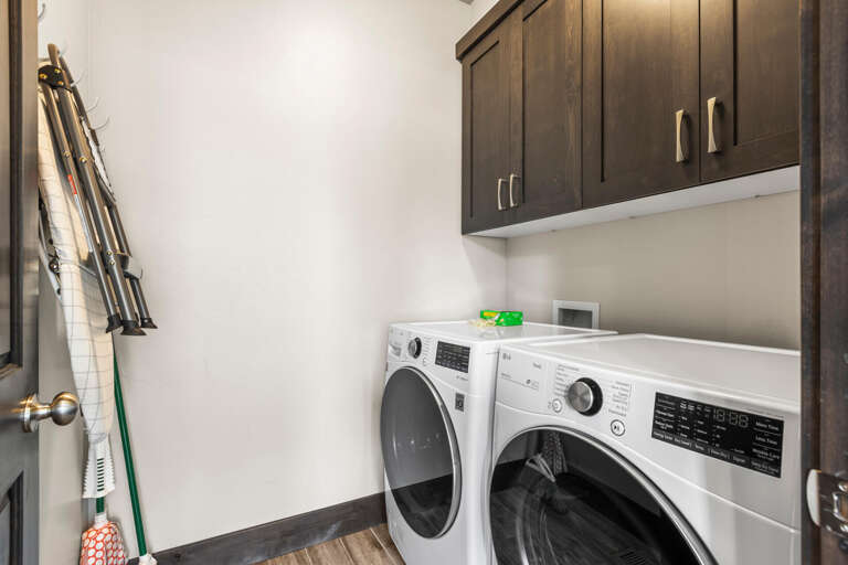 Keep your vacation wardrobe fresh in this well-equipped laundry room with modern appliances and ample storage for all your needs.