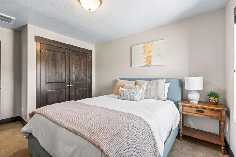Drift into peaceful sleep in your cozy bedroom, featuring plush bedding, warm wood accents, and thoughtful touches that create the perfect retreat.