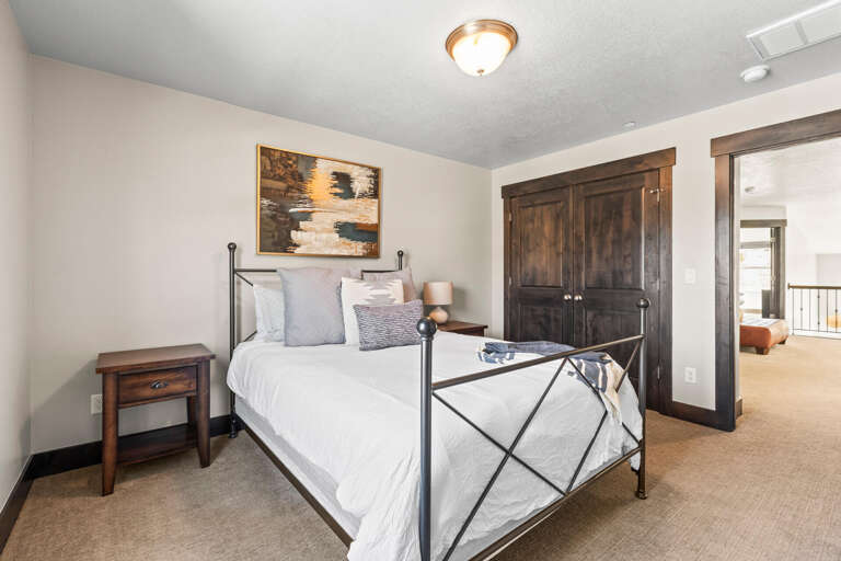 Settle into your cozy bedroom featuring crisp linens and rustic touches that create the perfect mountain retreat atmosphere.