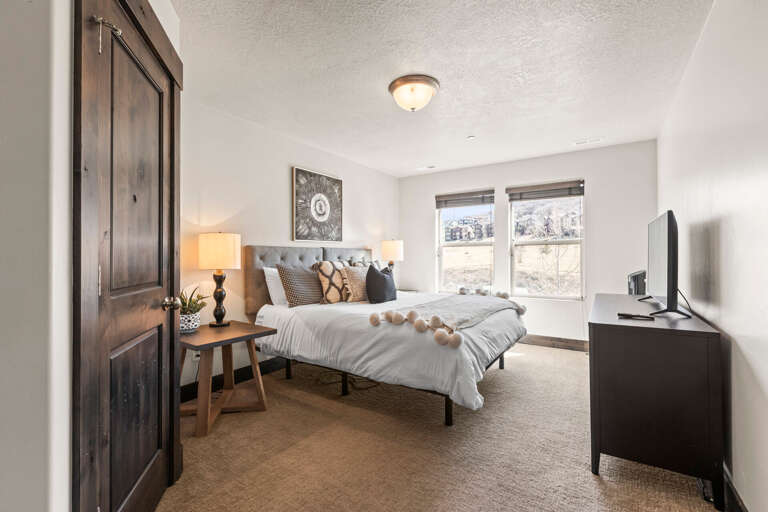 Sink into your cozy retreat with mountain views, plush bedding, and warm modern touches that make relaxation effortless.
