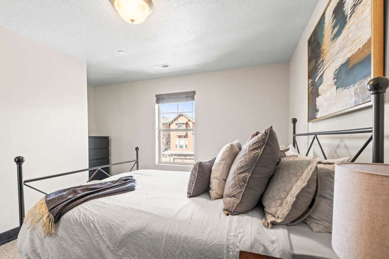 Sink into crisp linens and plush pillows in your serene bedroom retreat, where soft natural light creates the perfect atmosphere for rest.