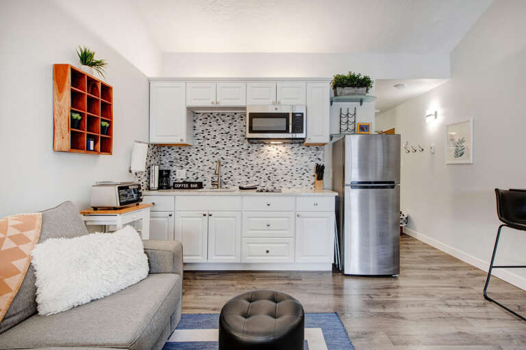 Your stylish open-plan retreat combines a fully equipped kitchen with cozy living space, perfect for cooking and relaxing.