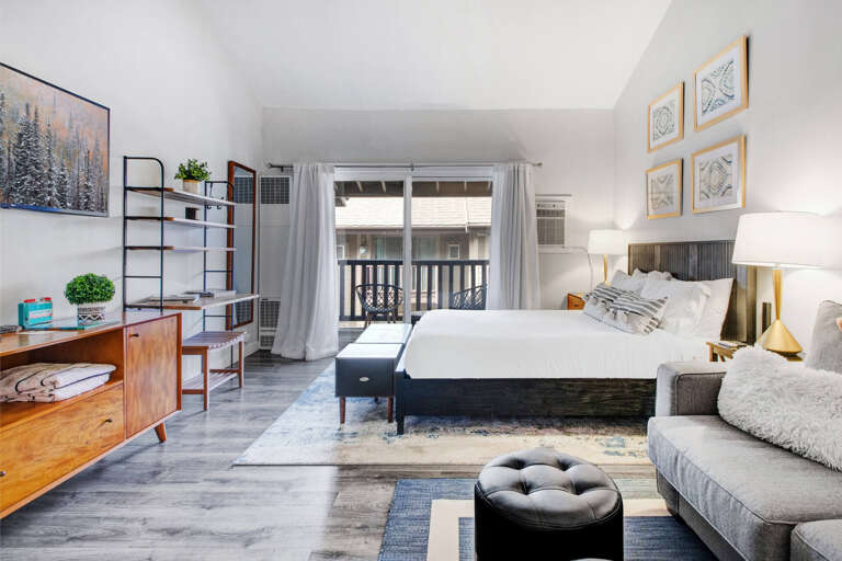Unwind in your stylish studio with plush bedding, cozy seating, and thoughtful touches that make this space feel like home.