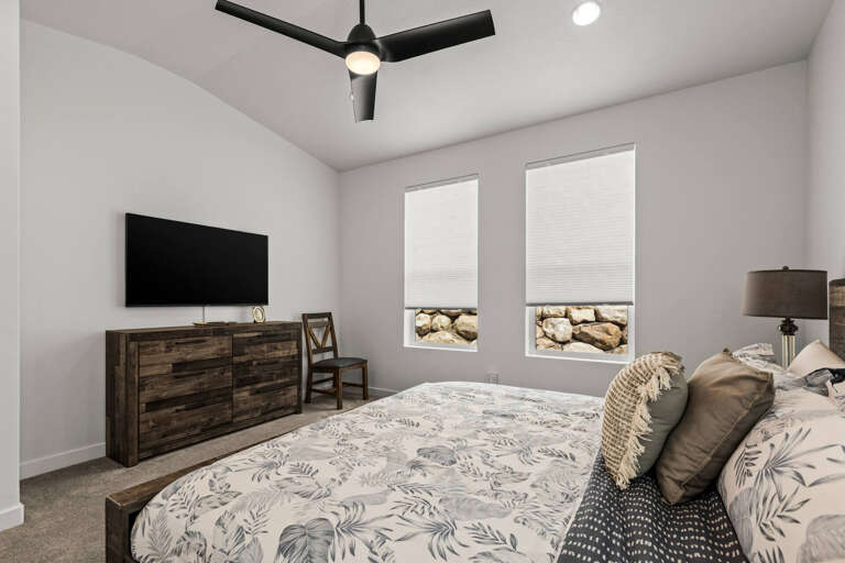 Drift off under your private ceiling fan in this serene bedroom with natural light streaming through dual windows and a flat-screen for your favorite shows.