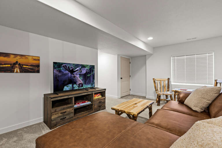 Sink into plush seating while your favorite shows play on the large screen—cozy rustic touches and soft throws invite you to unwind completely.