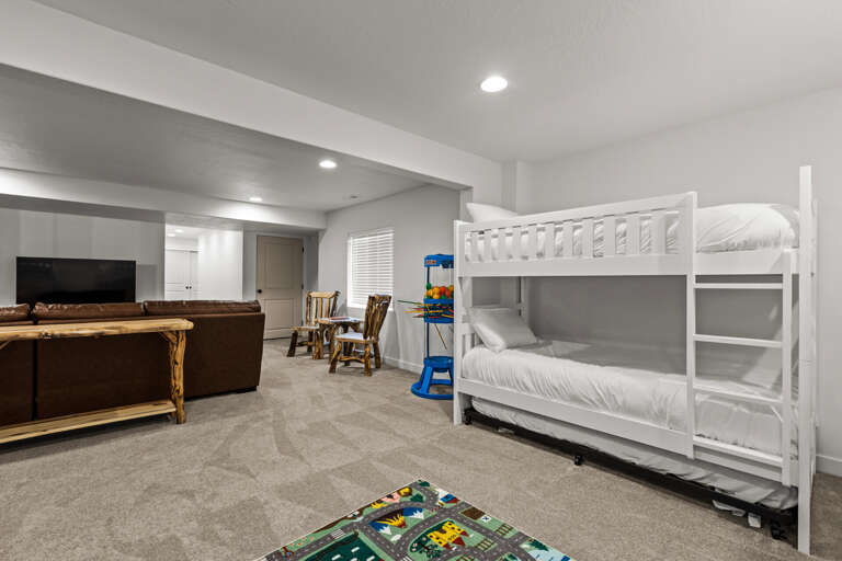 Your family-friendly space awaits with cozy bunk beds, a play rug for the kids, and a comfortable lounge area where everyone can gather for movie nights and quality time together.