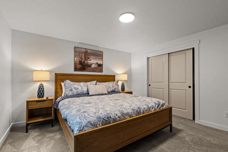 Picture yourself drifting off in this serene bedroom, bathed in warm lamplight. The plush queen bed and soft linens promise restful nights after your adventures.