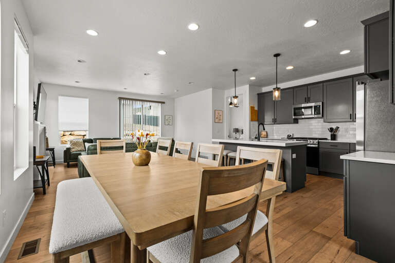 Gather around your spacious dining table for memorable meals, with the sleek open kitchen perfect for culinary adventures.