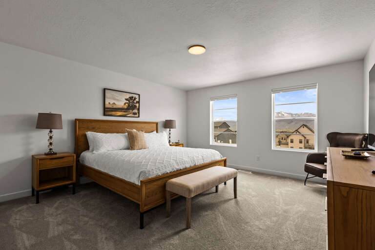 Relax in your peaceful bedroom with mountain views and warm wood furnishings for a restful night's sleep.