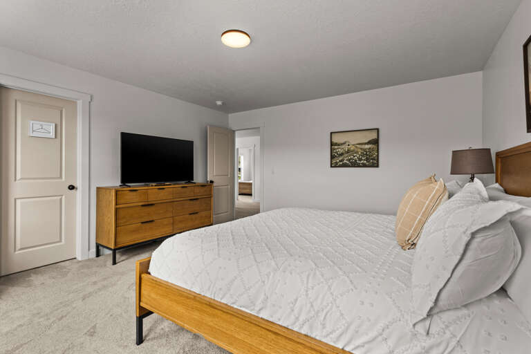Unwind in your cozy bedroom with plush linens, modern furnishings, and entertainment at your fingertips.