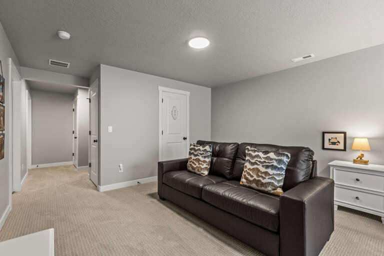 Unwind in your private basement retreat with plush leather seating and warm lighting for peaceful relaxation.