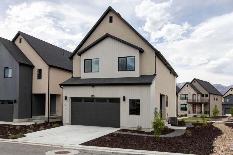 Modern property building featuring contemporary architecture in a well-developed residential neighborhood with mountain backdrop and manicured landscaping.