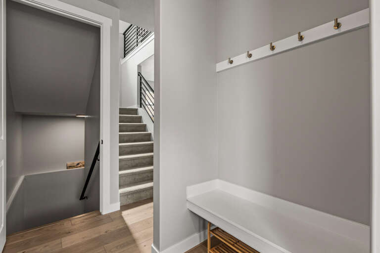 You'll love this stylish mudroom with built-in bench and coat hooks, perfect for storing your gear after exploring the city.